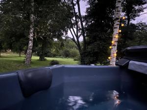 a pool of water with trees in the background at Les Hulottes in Le Vrétot