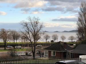 a house with cars parked in a parking lot at 106 Brynmill - Room 9 - Sea Views in Sketty