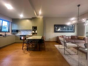 a living room with a couch and a table at Apartamento Sta Cruz 2 Dormitorios in A Coruña