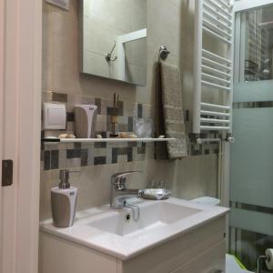 łazienka z umywalką i lustrem w obiekcie Apartment Tirso Molina w Madrycie