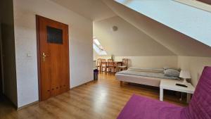 a attic bedroom with a bed and a staircase at Villa Zosia in Rowy
