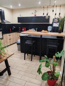 eine Küche mit einer schwarzen Insel in einem Zimmer in der Unterkunft Maison de village sur 2 étage in Saint-Gilles