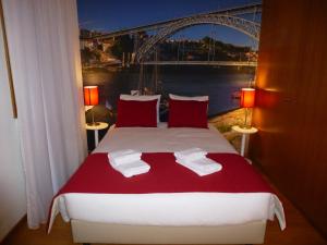 a bedroom with a bed with a view of a bridge at BRA.com Apartments Oporto Bonfim in Porto