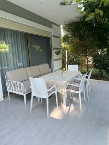 a white table and chairs on a patio at Villa Amalia Perla Resort in Draçi