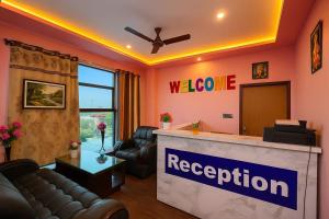 a waiting room with a reception desk with a couch at Golden M Riz Hotel & Restuarant in Lucknow