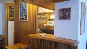 a kitchen with a wooden counter and a refrigerator at Résidence Nova 3 - Appartement 2 pièces 7 personnes proche des pistes MAE-7974 in Arc 1800 +18 photos