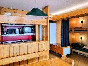 a room with a kitchen and a bunk bed at Résidence Nova 3 - Appartement 2 pièces 6 personnes proche des pistes MAE-8014 in Arc 1800 +16 photos