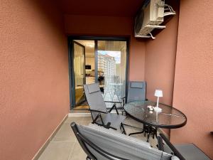 a dining room with a table and chairs and a balcony at Mount Inn Desetka in Zlatibor