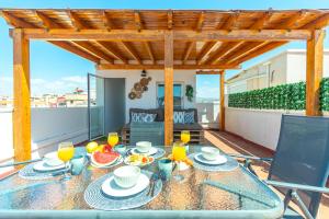 a table with food and drinks on a patio at La Azotea - By Aloha Palma in Águilas