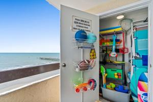 a closet with a door open to the beach at Sea Pointe 507 - Oceanfront in Myrtle Beach