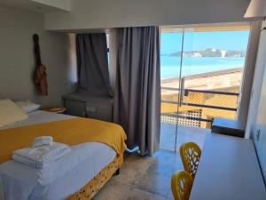 a bedroom with a bed and a view of the ocean at CosteiraPRAIASOLPontaNegra, Natal-RN in Natal +65 photos