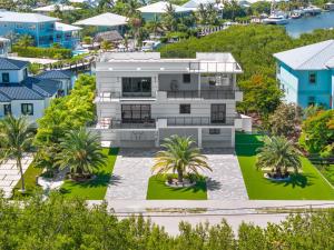 an aerial view of a house with palm trees at Ocean Muse - Lux Waterfront Escape - Pool - Dock in Marathon +90 photos