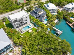 an aerial view of a house and the water at Ocean Muse - Lux Waterfront Escape - Pool - Dock in Marathon