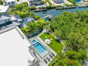 an aerial view of a house with a swimming pool at Ocean Muse - Lux Waterfront Escape - Pool - Dock in Marathon