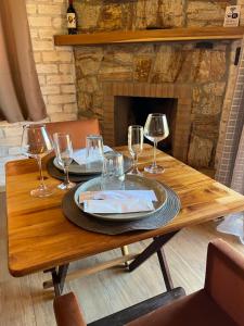 a wooden table with glasses of wine on it at Pousada do valle in Monte Verde