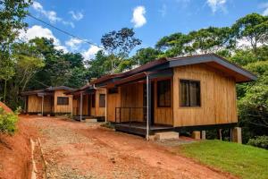 a row of wooden houses on a dirt road at La jungla ecolodge in San Juan