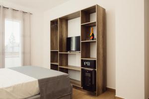 a bedroom with a bed and a book shelf at B&b i Parenti in Palmi