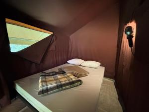 a small room with a bed in a tent at Camping Onlycamp de Tignes in Tignes