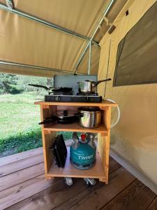 a stove in a tent with two pots and pans at Camping Onlycamp de Tignes in Tignes