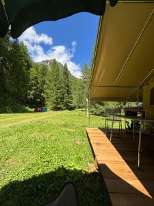 a large tent with a table on a grass field at Camping Onlycamp de Tignes in Tignes