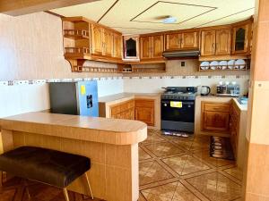 a kitchen with wooden cabinets and a counter top at Residence in Chignahuapan in Chignahuapan