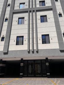 a tall building with a bunch of windows at Modern Apartment in Jeddah