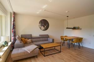 a living room with a couch and a table at Ferienwohnung Bad Sachsa Harz II in Bad Sachsa