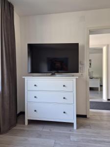a white dresser with a television on top of it at Ferienwohnung Waldblick 2 für 4 Personen und max 2 Hunde in Simmerath
