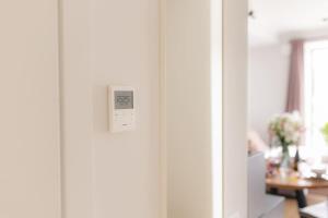 a door with a light switch and a table at La Tereza Apartments in Ķesterciems