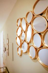a bunch of mirrors hanging on a wall at Via Manno 11 Rooms in Iglesias