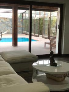 a living room with a couch and a table and a pool at Coparelia in Villarrobledo