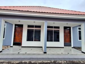 a building with four windows on a wooden deck at Arusha Serene Apartments in Arusha +1 photo