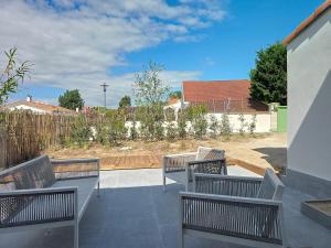 three benches sitting on top of a patio at Feet in the water, 100 m from the city center in La Tranche-sur-Mer