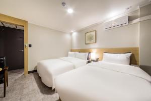 En eller flere senger på et rom på Pyeongtaek Stay Tourist Hotel
