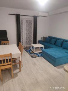 a living room with a blue couch and a table at Holiday Home in Trebinje