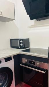 a kitchen with a microwave on top of a counter at Vénus #Love room# in Hoguet