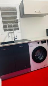 a washing machine in a kitchen with a sink at Vénus #Love room# in Capesterre-Belle-Eau +15 photos