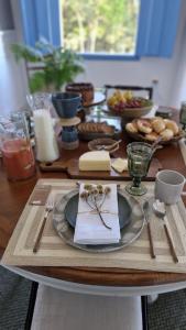 a wooden table with plates and utensils on it at Chateau Tiradentes in Tiradentes