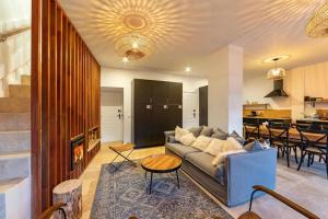a living room with a couch and a table at Maison de Sophie in Rencurel