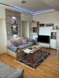 a living room with a couch and a table at Apartment in Veles