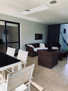 a living room with white chairs and a couch at Casa de campo, paz, tranquilidad in Concordia +12 photos