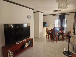 a living room with a large flat screen tv at Ananda in Jarabacoa