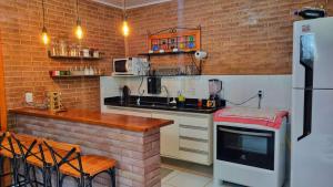 a kitchen with a counter and a refrigerator at Sítio Andrez in Santa Leopoldina