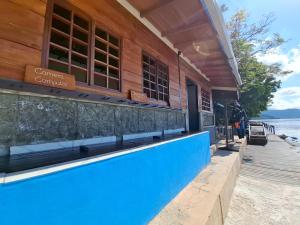 a restaurant on the beach next to a building at Nabuccos Spice Island Resort 
