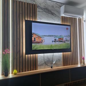 a flat screen tv sitting on a window sill at Ljubičica deluxe 2 - Novo - Privatno dvorište - Parking in Vrnjačka Banja