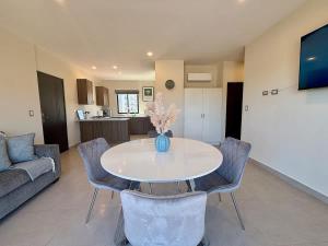 a living room with a white table and chairs at Vinedos del Mar 2BR 2BA with pool in Ensenada +27 photos