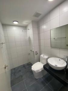 a bathroom with a toilet and a sink and a mirror at Chamber Residences KL At EZ Stay in Kuala Lumpur