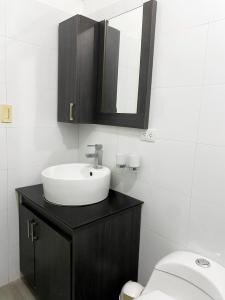 a bathroom with a sink and a toilet at Enjoy a 2 bedroom 2 bathroom apartment in Bella Vista in Porlamar