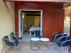 a patio with chairs and a table and a bed at Maison du Sacre-Coeur in Lourdes