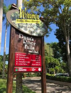 a sign for a dents river falls and dart park at Jamaica Coastal Getaway in Discovery Bay
